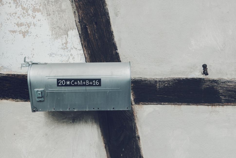 Free Image of Metal mailbox on aged wooden crossbeam 