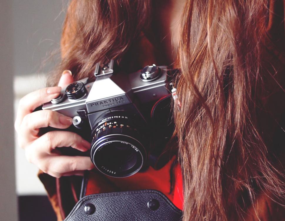 person-holding-a-vintage-praktika-camera.jpg