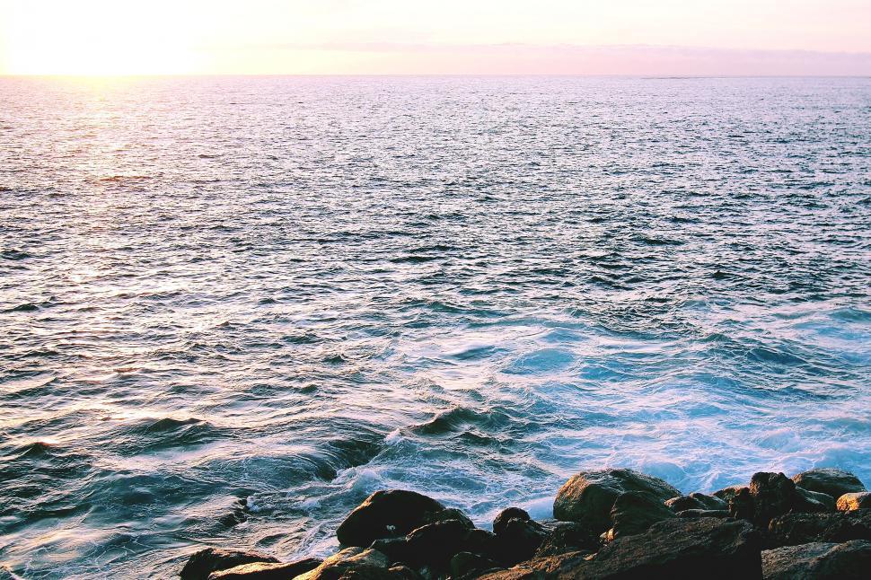 Free Image of Sunset over a tranquil ocean horizon 