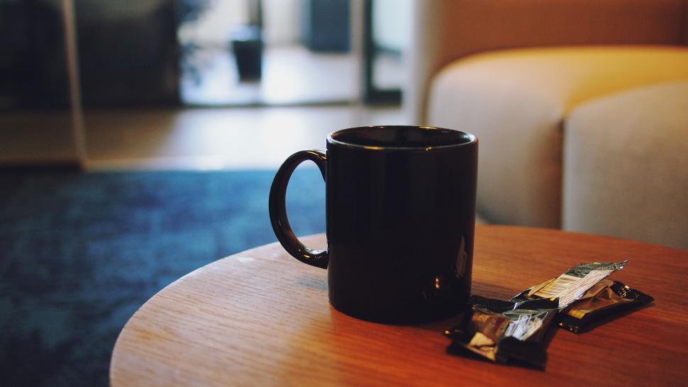 Free Image of Coffee mug with snacks on wooden table 