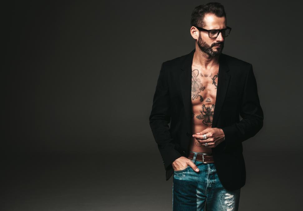 Free Image of A man with glasses and a black jacket 