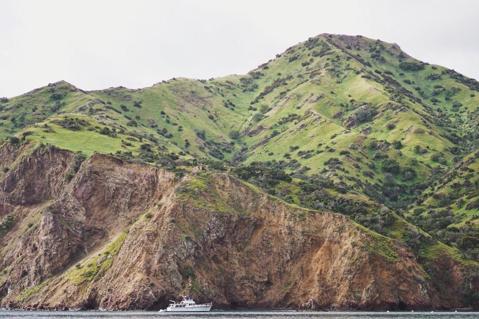 Free Image of Lush green hillside by the coastal cliffs 