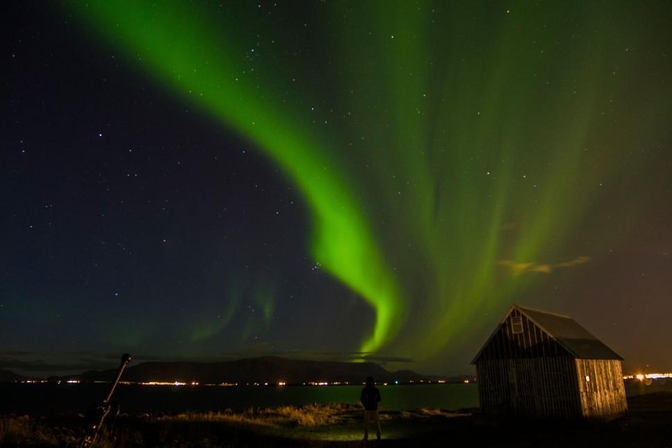 Free Image of Northern lights over quaint countryside shed 