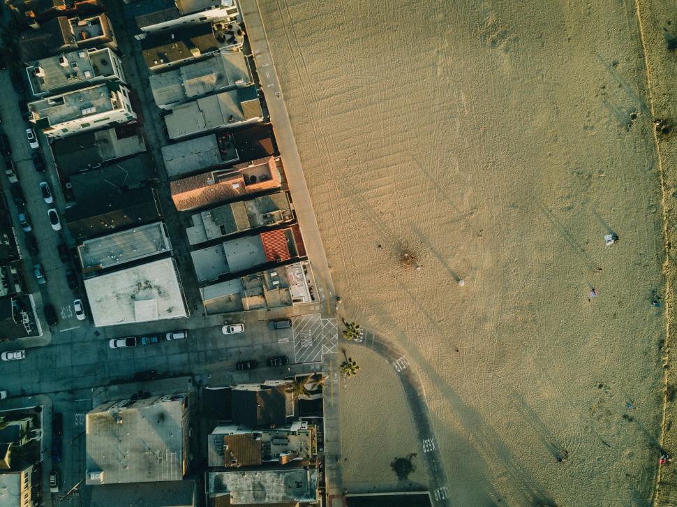 Free Image of Deserted sandy beach with urban backdrop 
