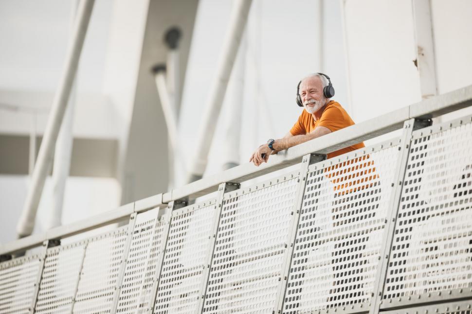 Free Image of Senior man enjoying music outdoors 
