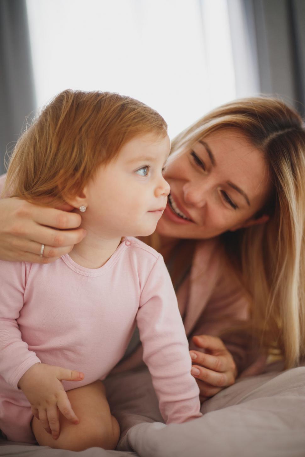 Free Image of Mother cuddling with her toddler daughter 