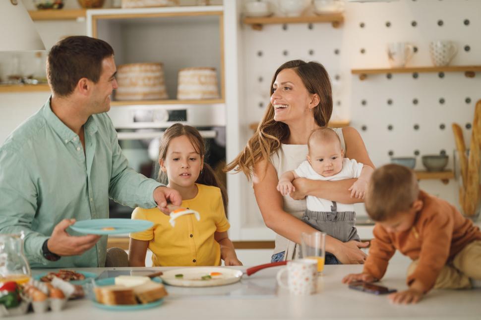 Free Image of Family enjoying meal in bright kitchen 
