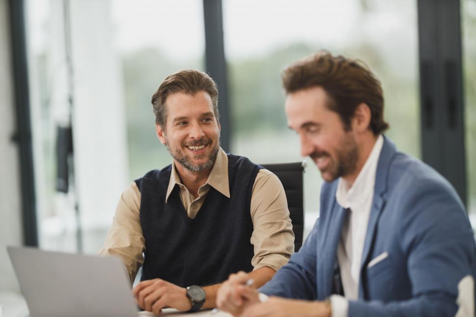 Free Image of Colleagues discussing a project happily 