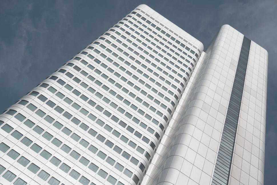 Free Image of Two towering buildings stretching into blue sky 