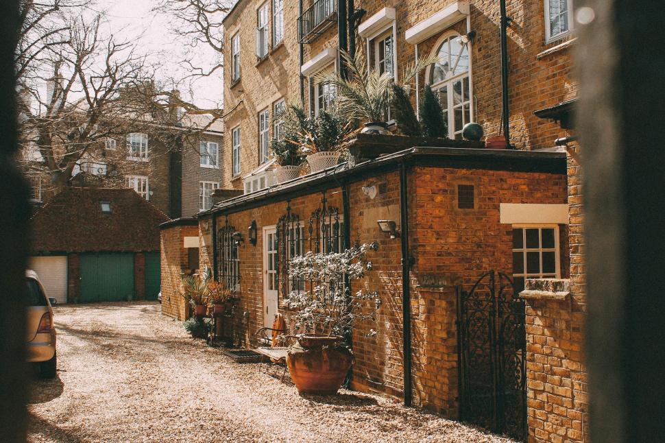 Free Image of Charming house with pots and brick facade 