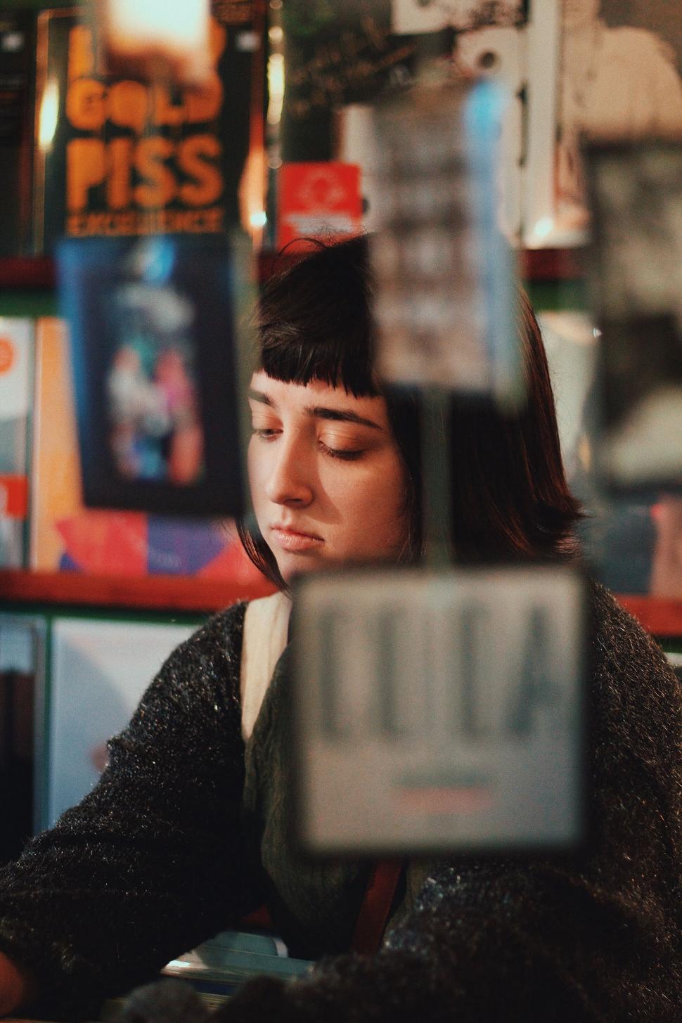Free Image of Pensive young person in a bar with vivid lighting 