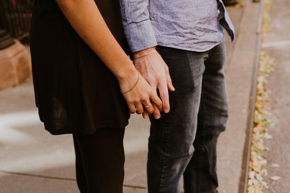 Free Image of Couple holding hands on an autumn day 
