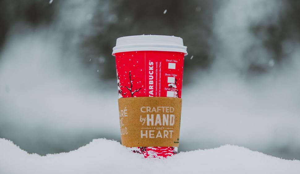 Free Image of Red Starbucks cup in wintry snow setting 