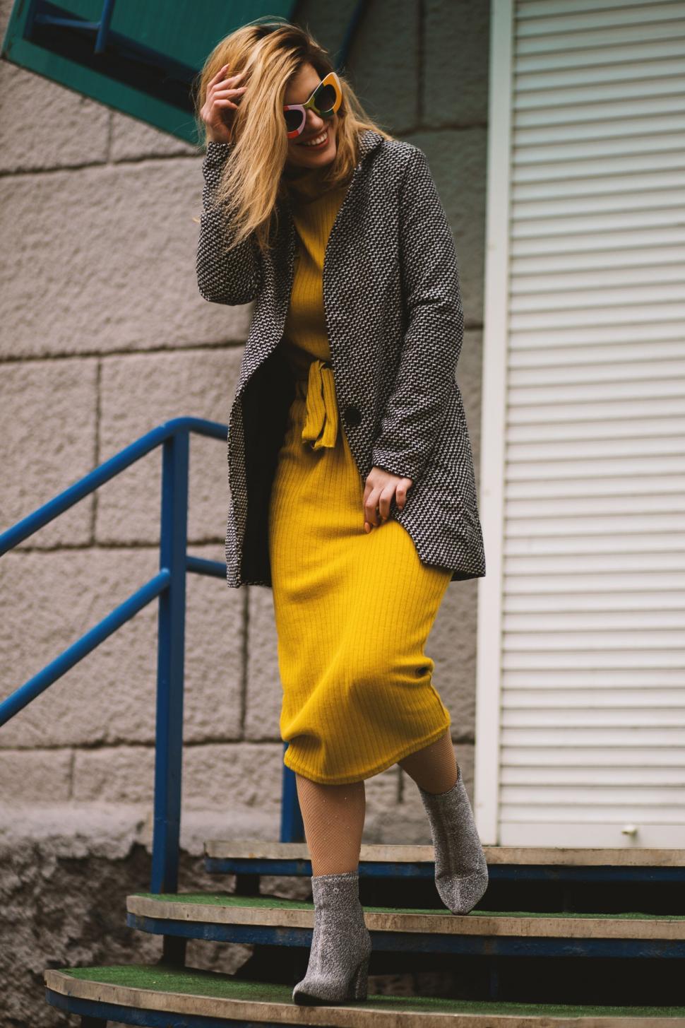 Free Image of Fashionable woman on stairs in urban setting 
