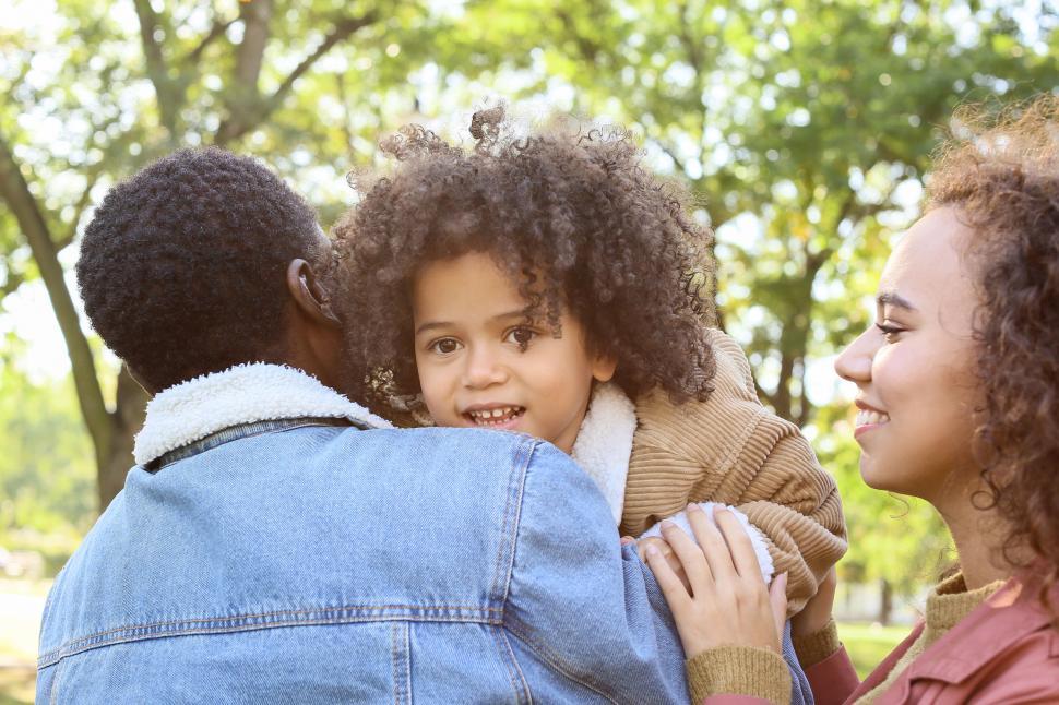 Free Image of Family engaged in a warm embrace outdoors 