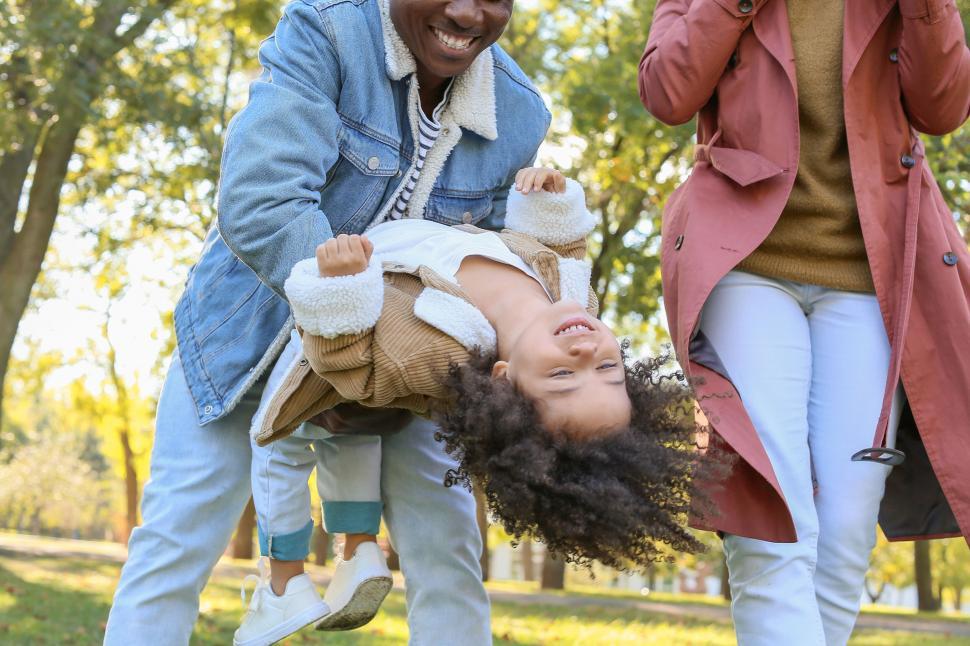 Free Image of Joyful family playing together in autumn park 