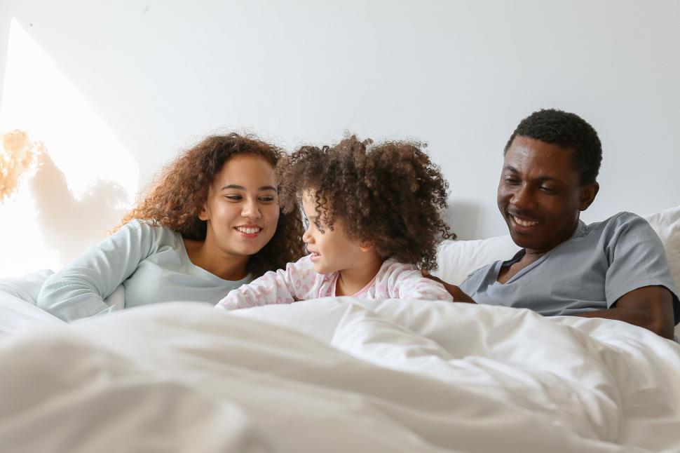 family-enjoying-time-together-on-a-bed.jpg