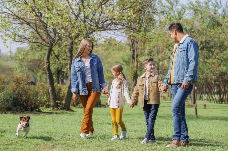 Free Image of Family and dog walking in nature setting 