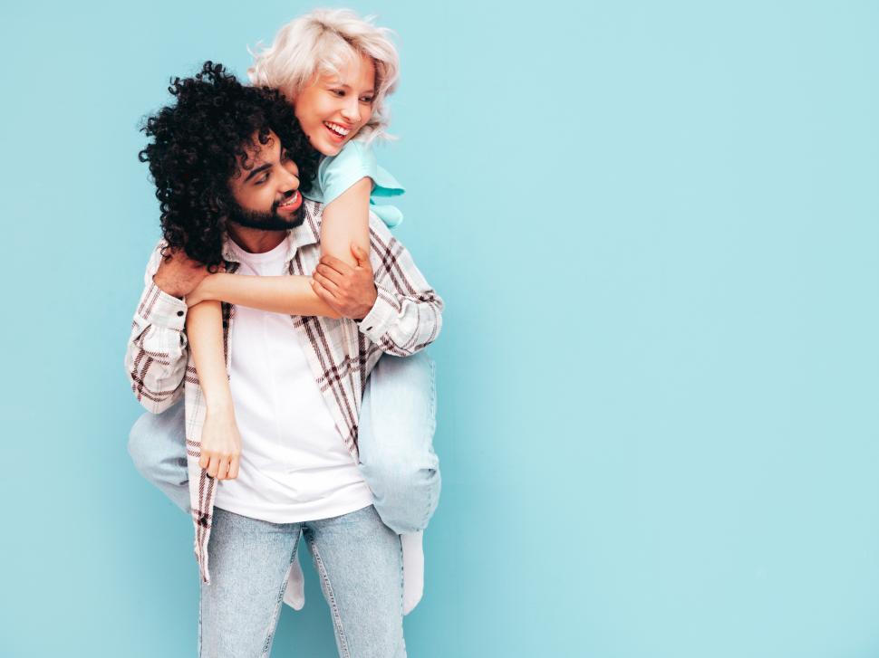 Free Image of A man carrying a woman on his back 
