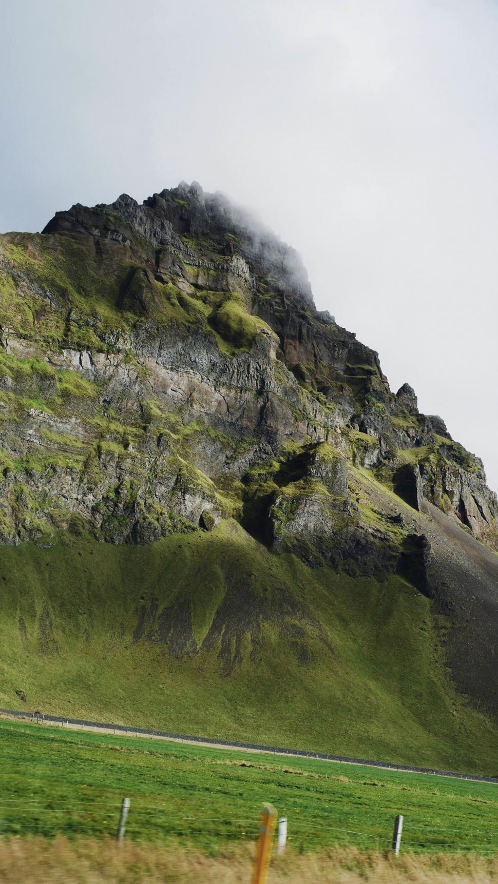 Free Image of Mystical mountain peak with clouds hovering 