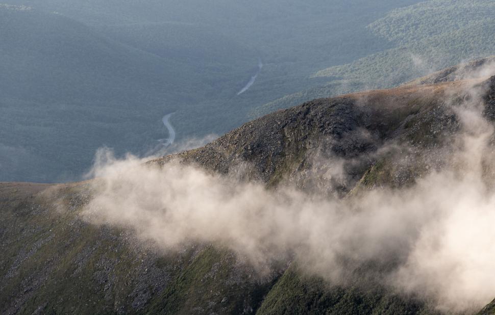 Free Image of Mountain peaks shrouded in swirling clouds 