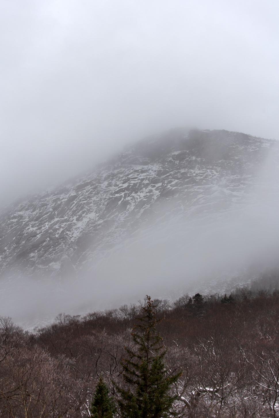 Free Image of Mountain shrouded in mist and snow 