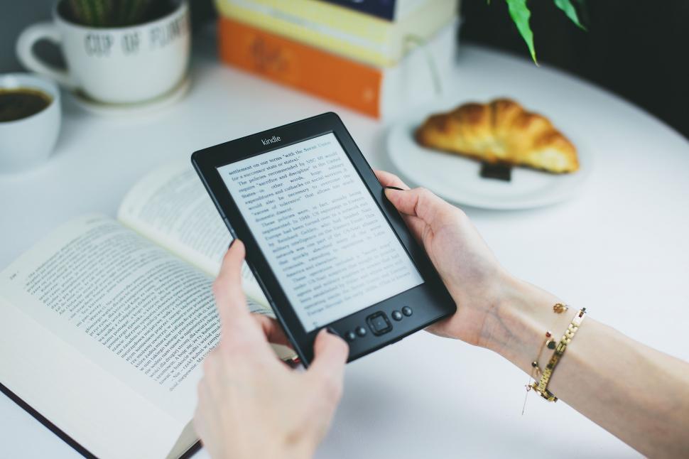 Free Image of Person holding eBook reader with text visible 