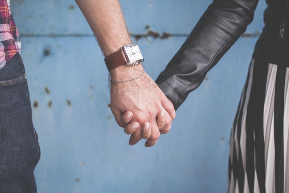 Free Image of Couple holding hands with a vintage wristwatch 