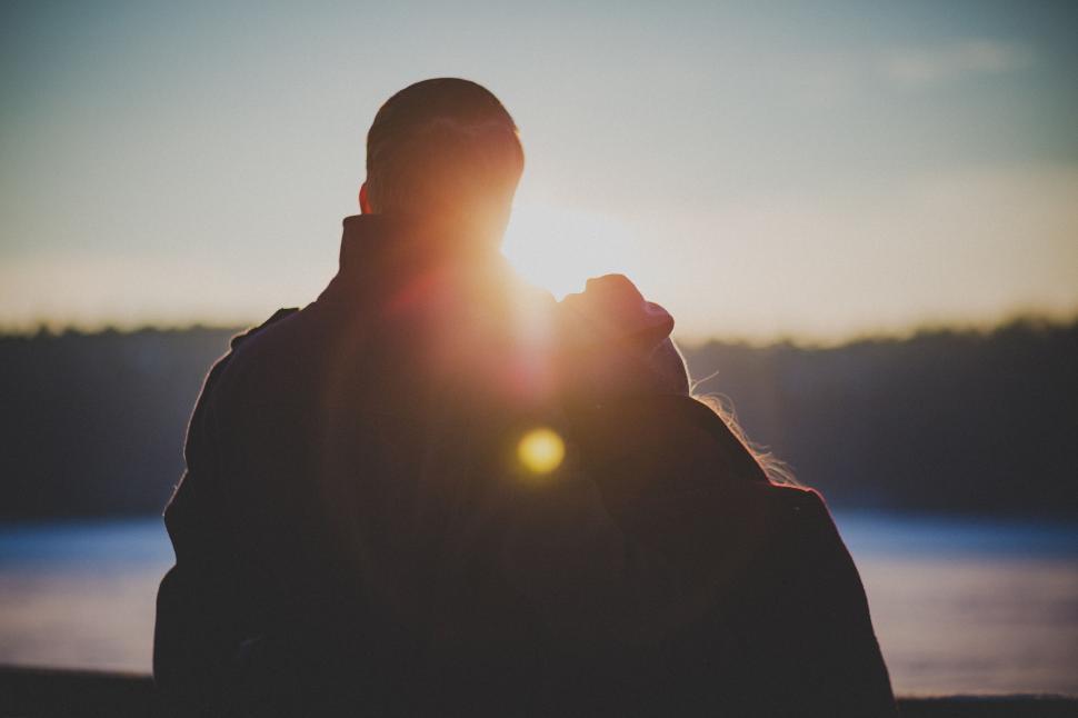 Free Image of Couple enjoying a sunset by the lake 