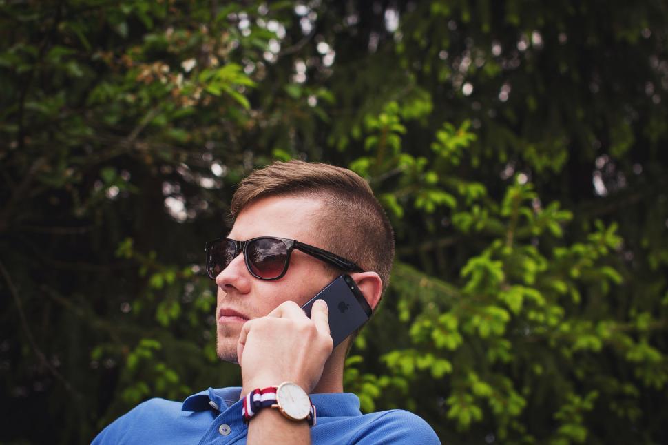 Free Image of Man in blue shirt with watch and blurred face 