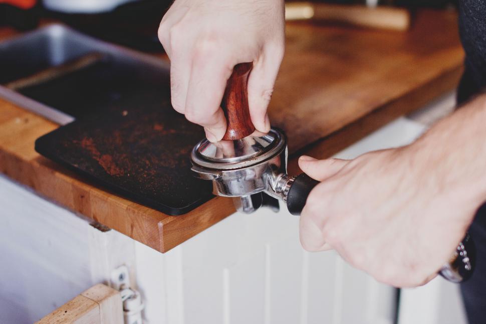 Free Image of Barista tamping coffee in a portafilter 