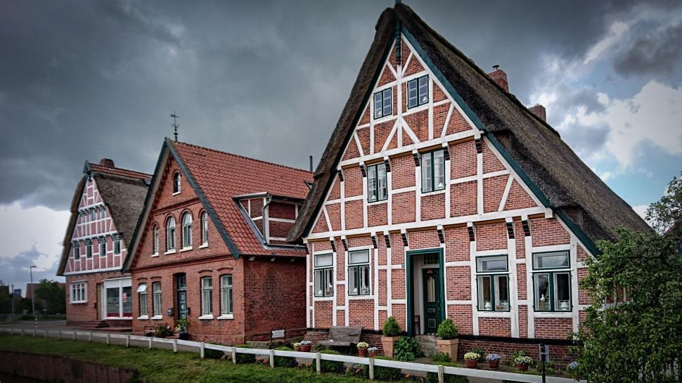 Free Image of Traditional half-timbered houses under dark sky 