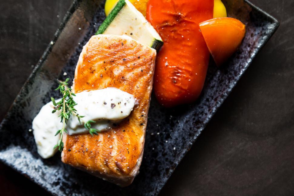 Free Image of Grilled salmon with veggies on stone plate 