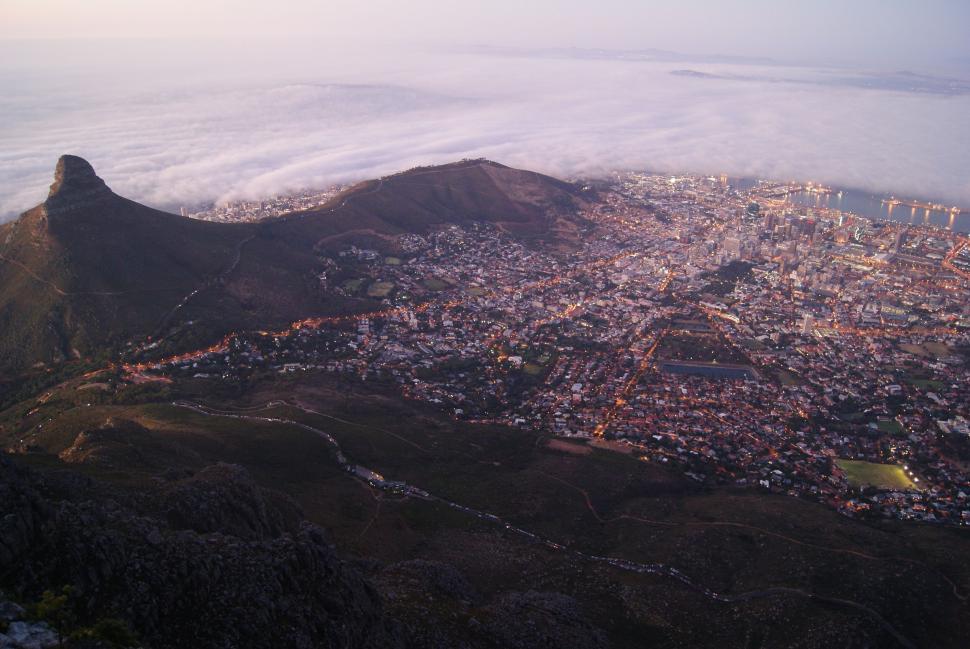 Free Image of Aerial view of cityscape enveloped by clouds 