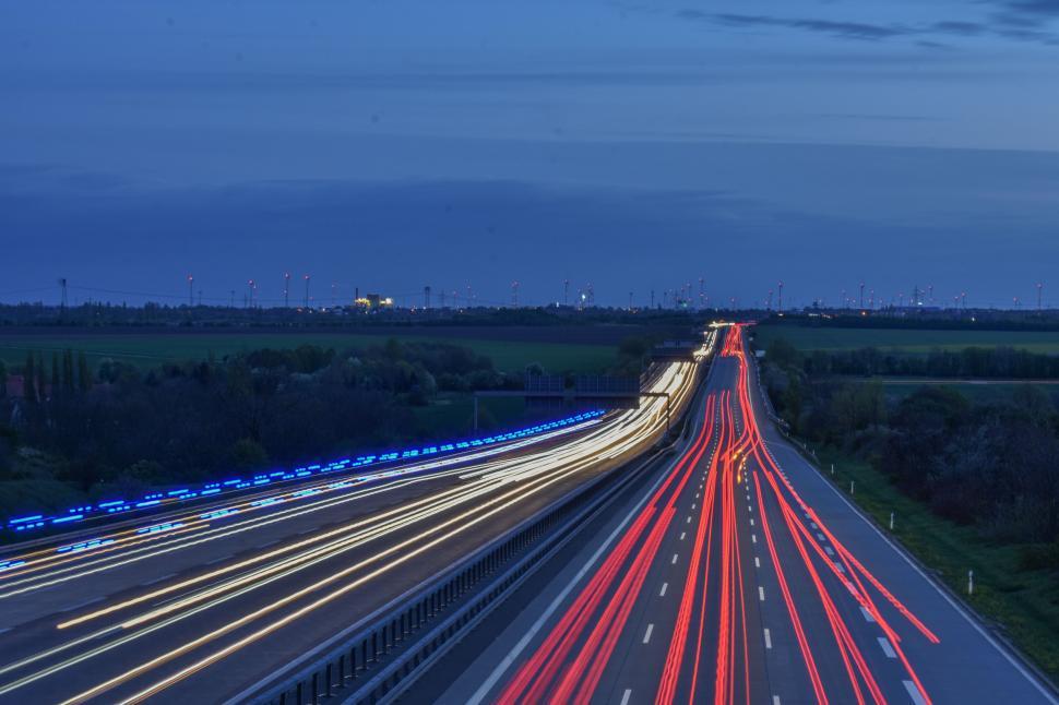 Free Image of Highway illuminated by vehicle lights at twilight 