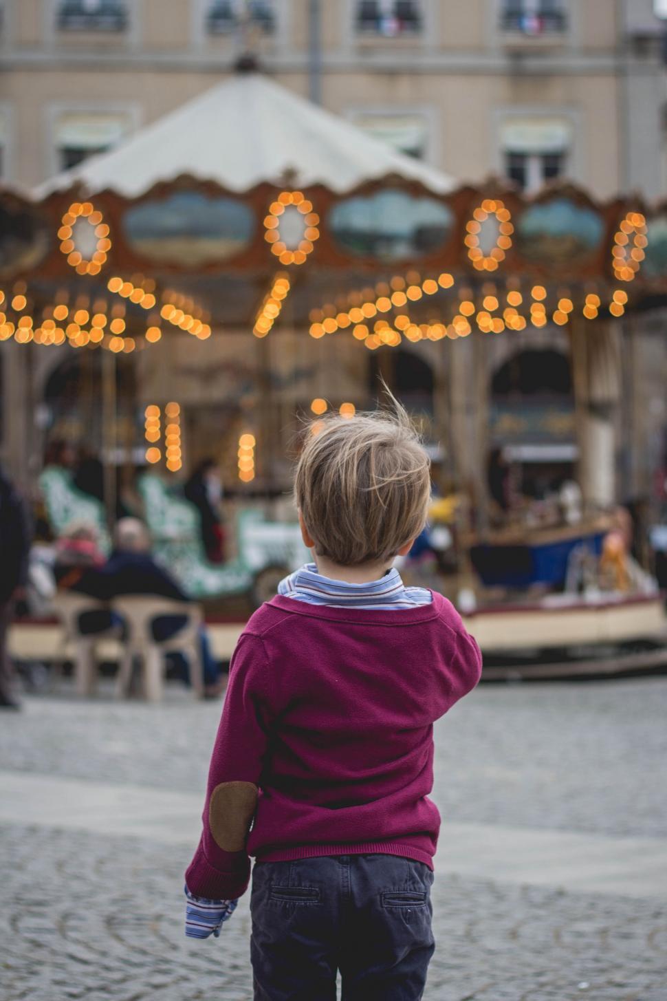 child-looking-towards-a-merry-go-round.j