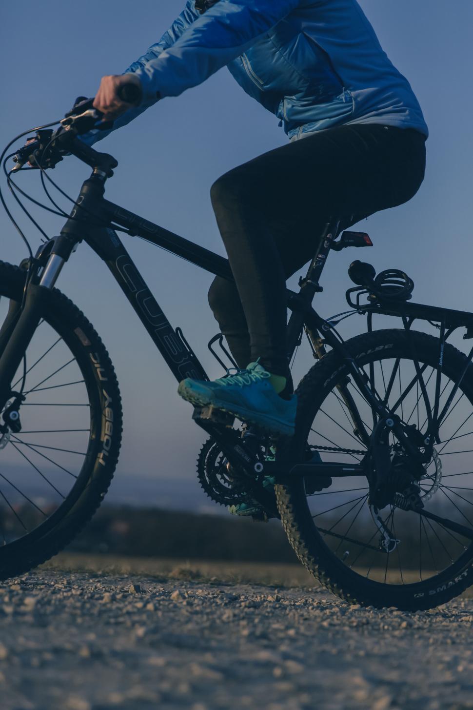 Free Image of Cyclist Riding at Dusk on Gravel Road 