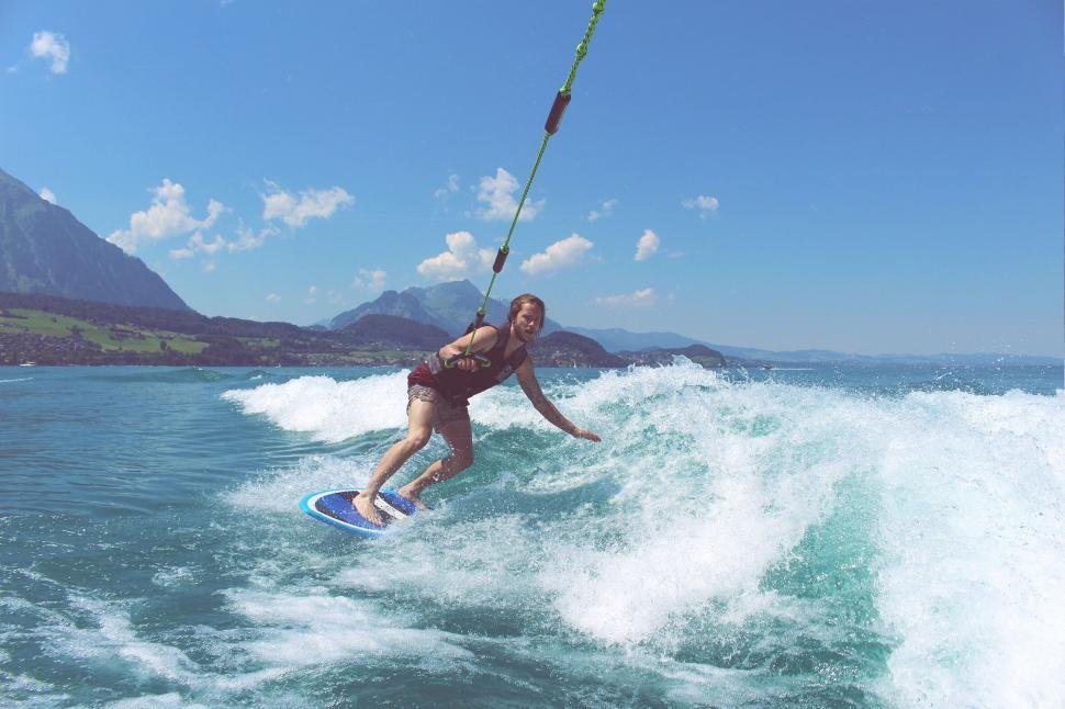 Free Image of Wakeboarder being towed on a sunlit lake 
