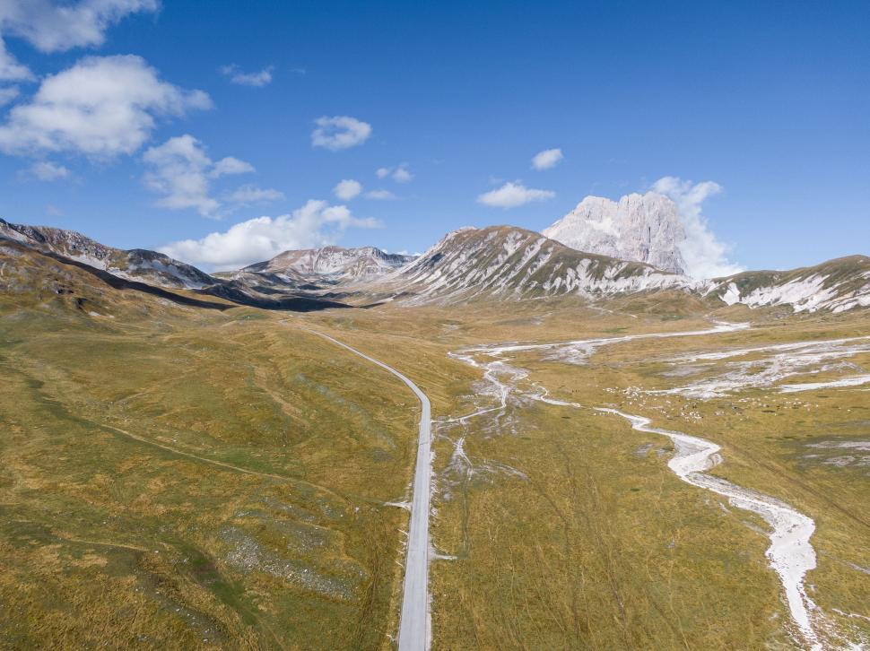 Free Image of Aerial view of a winding road in the mountains 