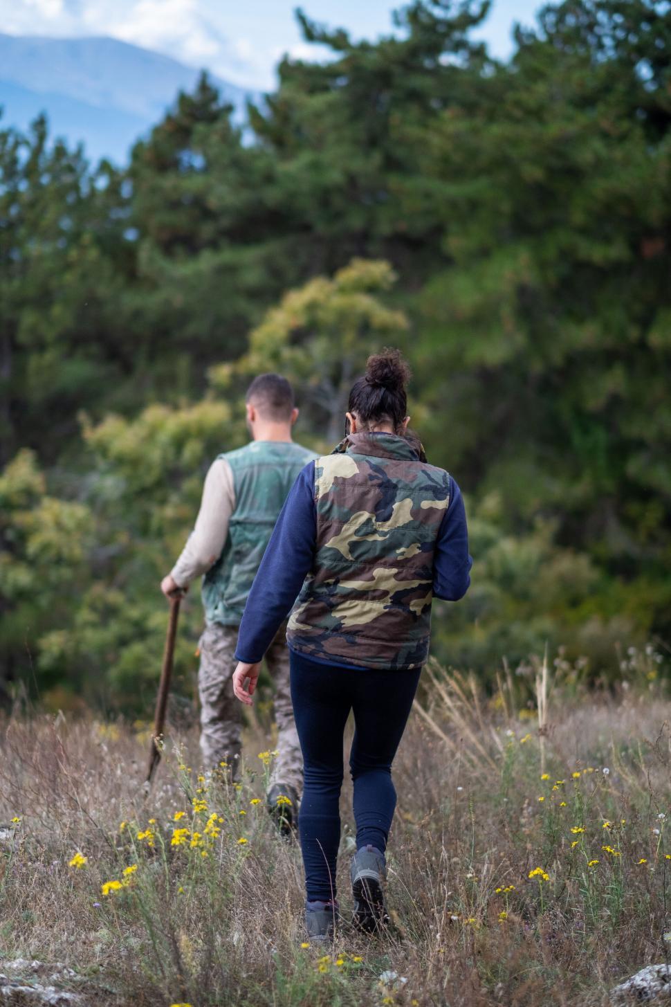 Free Image of Hikers walking through a mountainous terrain 