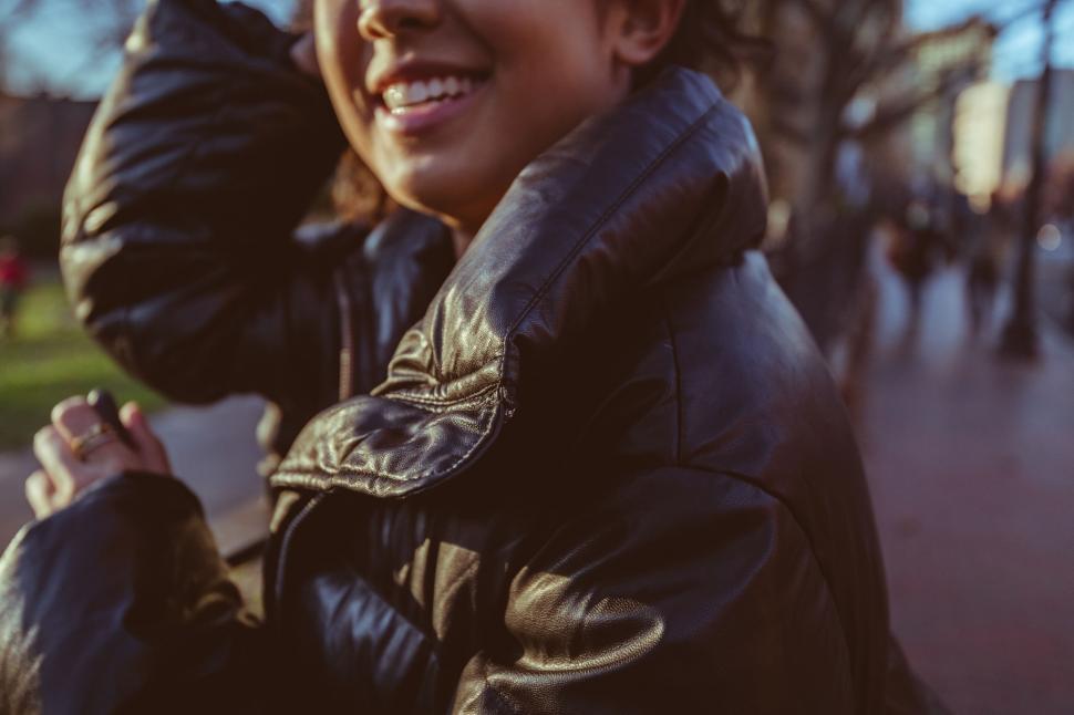 Free Image of Man in leather jacket sitting on bench 
