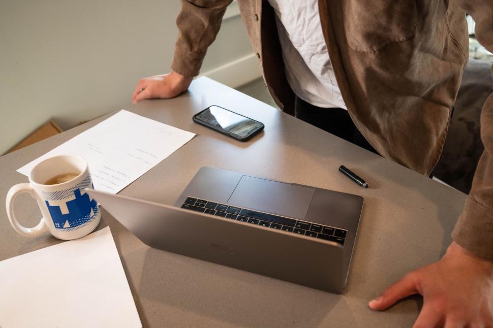 Free Image of Workspace with laptop, mug, and smartphone 