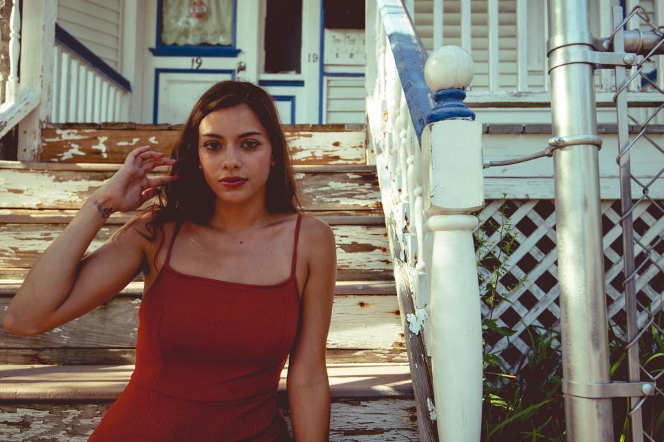 Free Image of Woman posing on wooden steps outdoors 