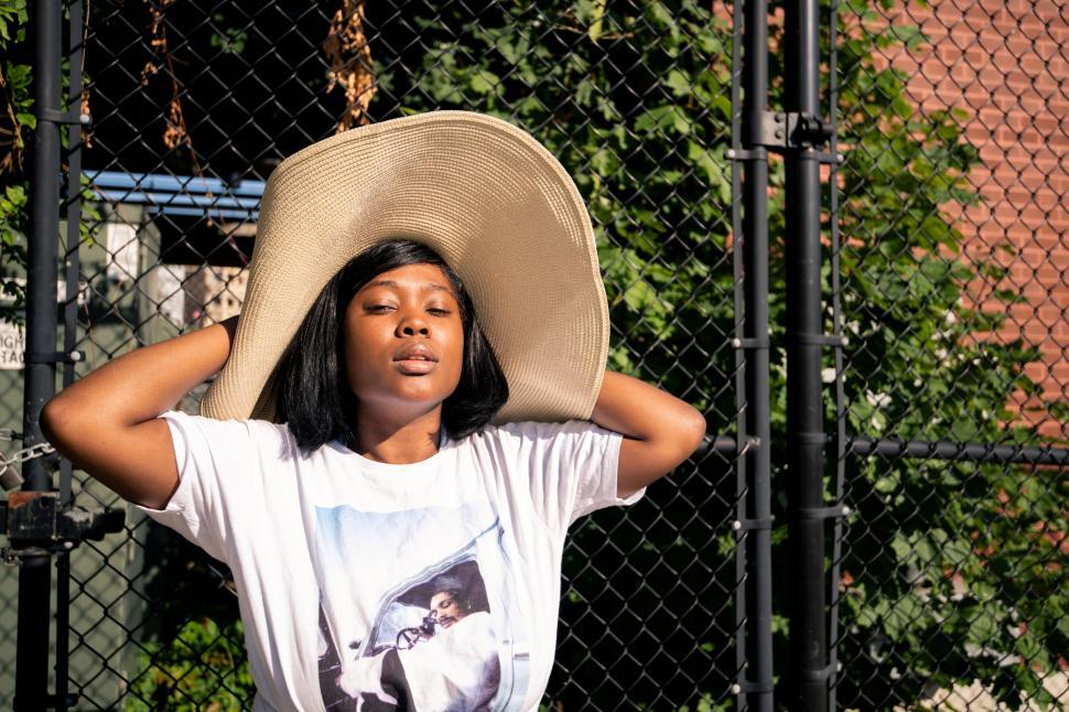 Free Image of Woman with sun hat on urban background 