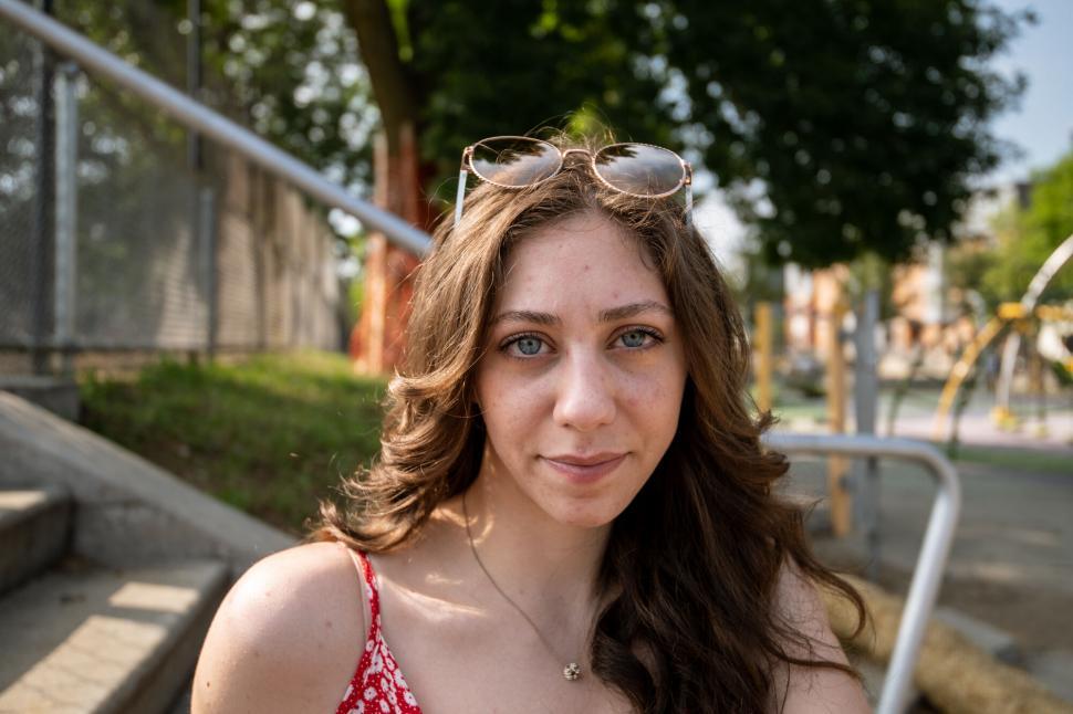 Free Image of Young woman with sunglasses on her head 