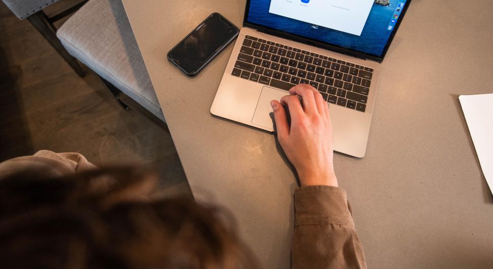 Free Image of Overhead view of hands typing on laptop 