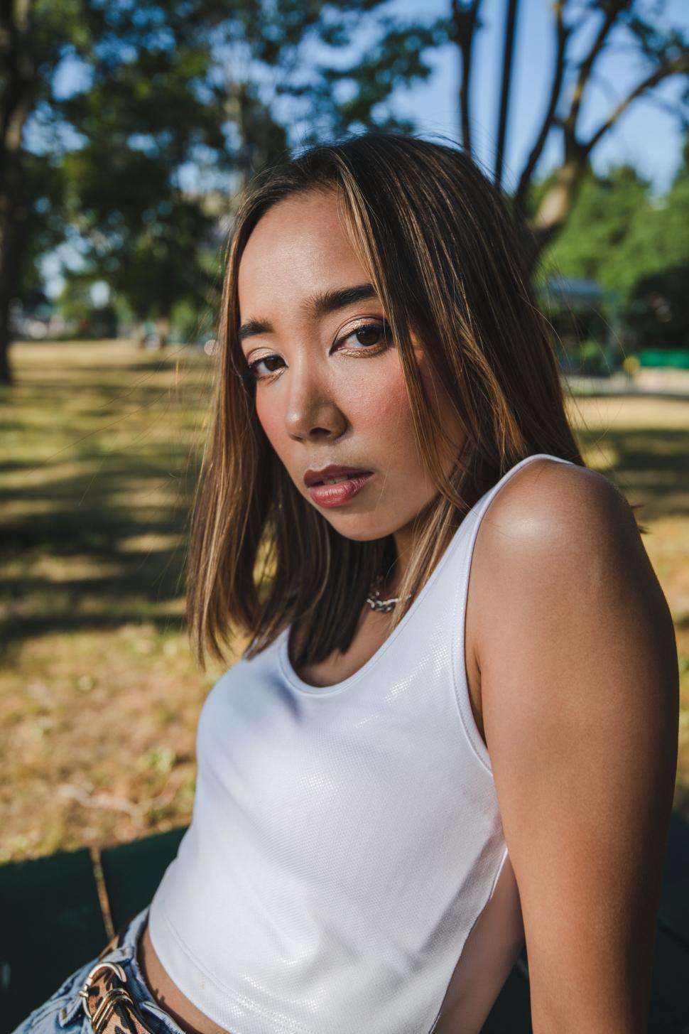 Free Image of Young woman posing in a park 