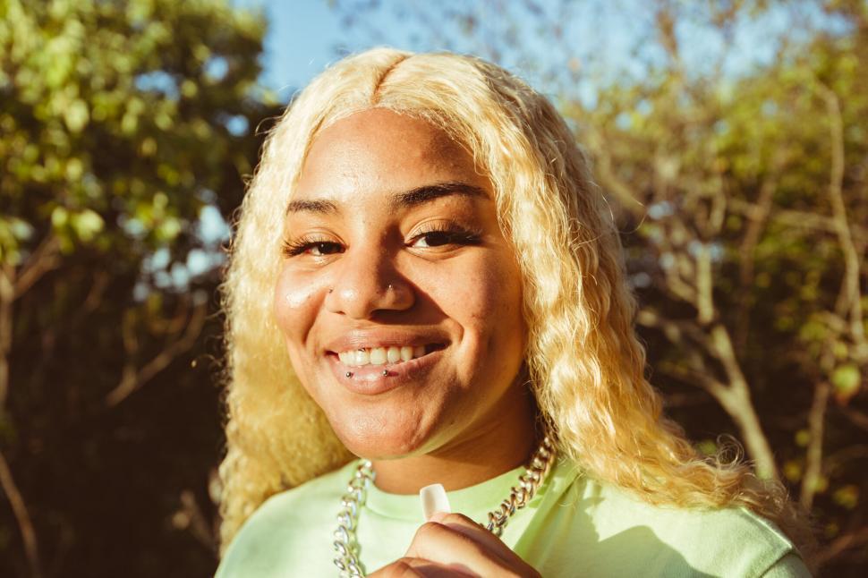 Free Image of Smiling young woman in sunlight 