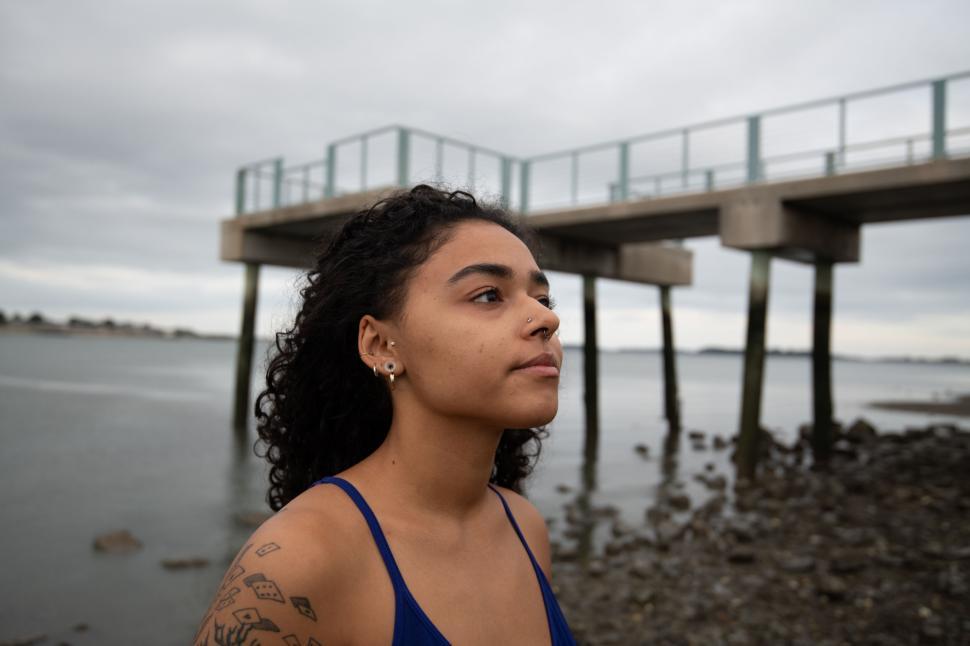 Free Image of Contemplative woman by the waterfront 