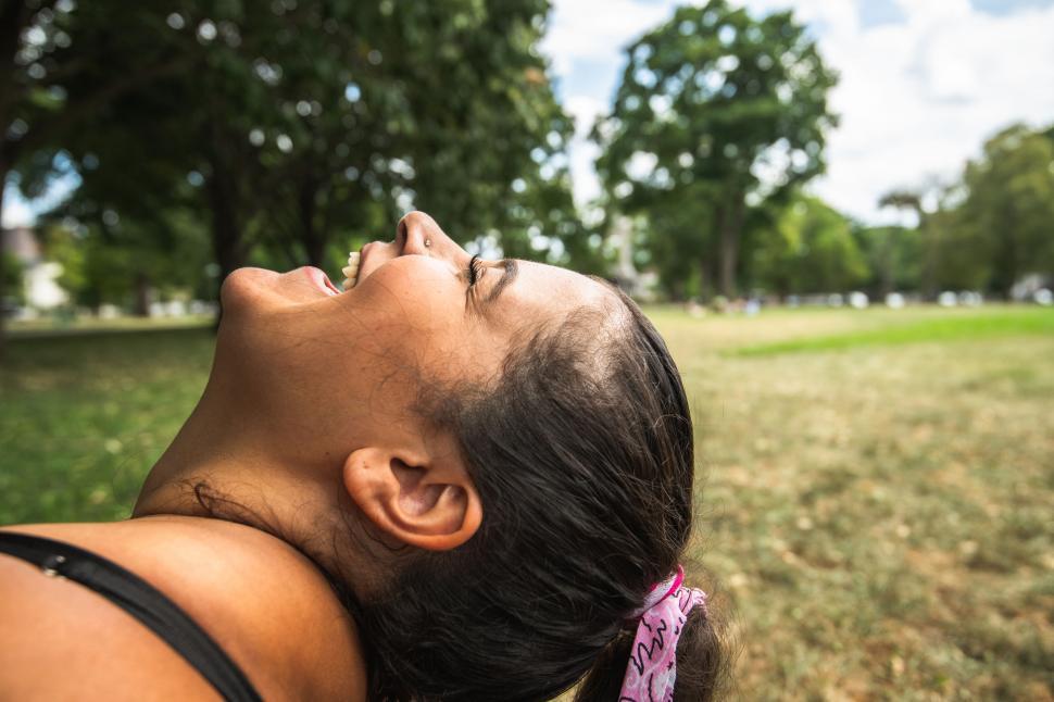 Free Image of Back view of woman in a park with blurred face 